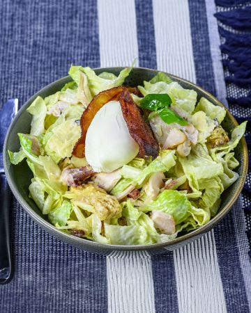 Uovo in camicia con insalata di baccalà, bacon e pepe nero